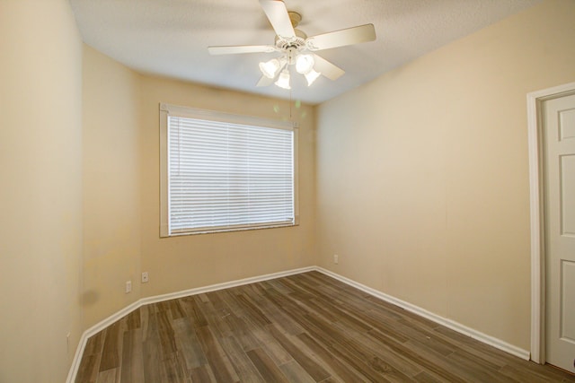 empty room featuring dark wood-type flooring, a textured ceiling, and ceiling fan