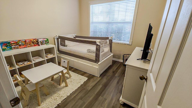 bedroom with dark hardwood / wood-style flooring