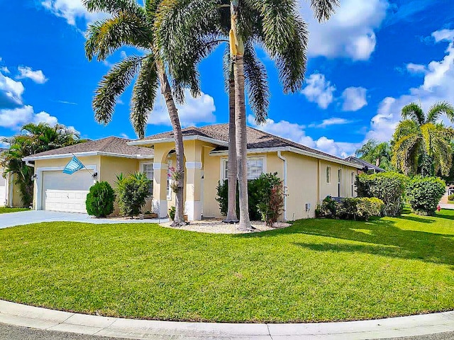 view of front of home featuring a garage and a front lawn