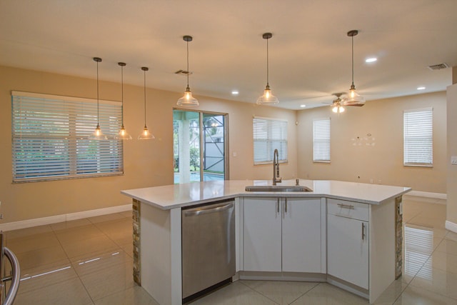 kitchen with light tile patterned floors, sink, dishwasher, hanging light fixtures, and an island with sink