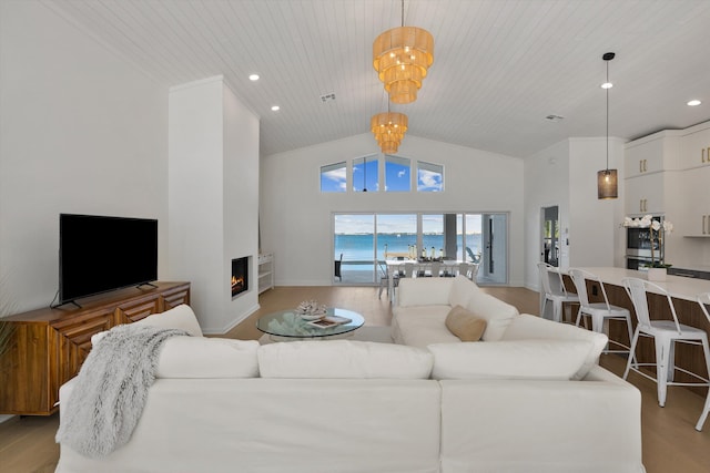 living room featuring light hardwood / wood-style floors, a water view, high vaulted ceiling, wooden ceiling, and a notable chandelier