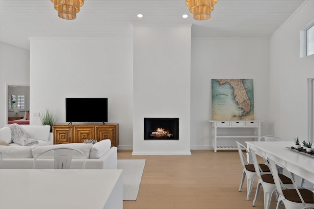 living room featuring ornamental molding and light hardwood / wood-style floors