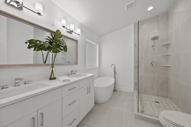 full bathroom with vanity, a textured ceiling, tile patterned flooring, shower with separate bathtub, and toilet