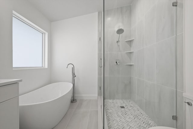 bathroom with vanity, plus walk in shower, and tile patterned flooring