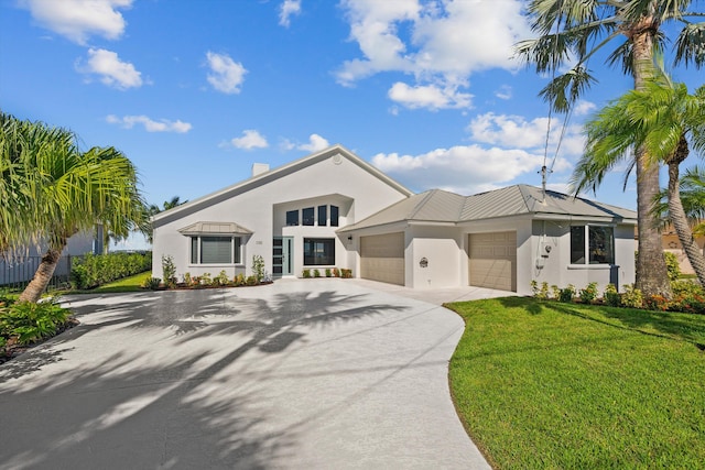 view of front facade featuring a front yard and a garage