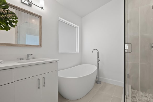 bathroom featuring plus walk in shower, tile patterned floors, and vanity