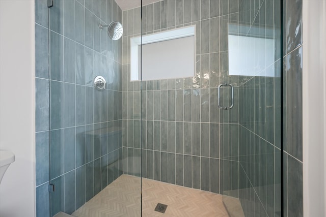 bathroom with an enclosed shower and toilet