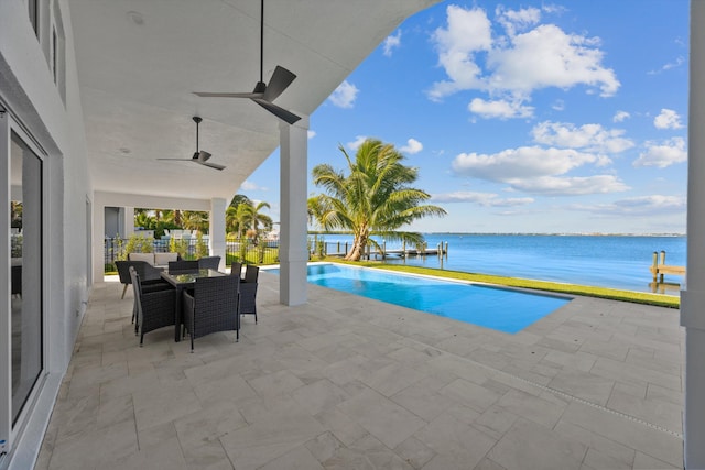 view of pool featuring a patio, a water view, and ceiling fan