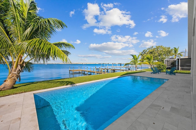 view of pool with a lanai, a patio, a water view, and a dock