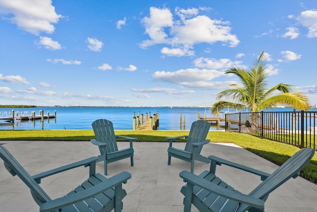 view of patio with a boat dock and a water view