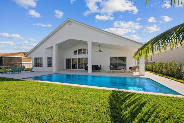 view of pool featuring a lawn, a patio, and ceiling fan