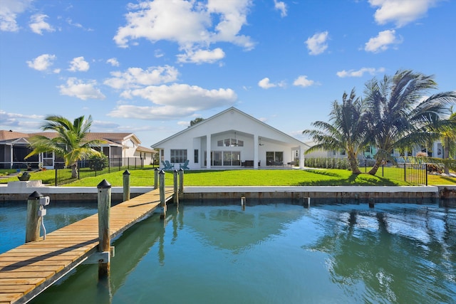 view of dock featuring a water view and a yard