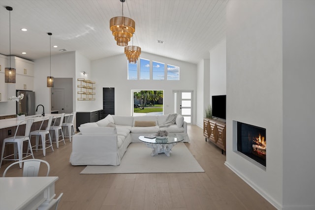 living room with wooden ceiling, light hardwood / wood-style floors, and high vaulted ceiling