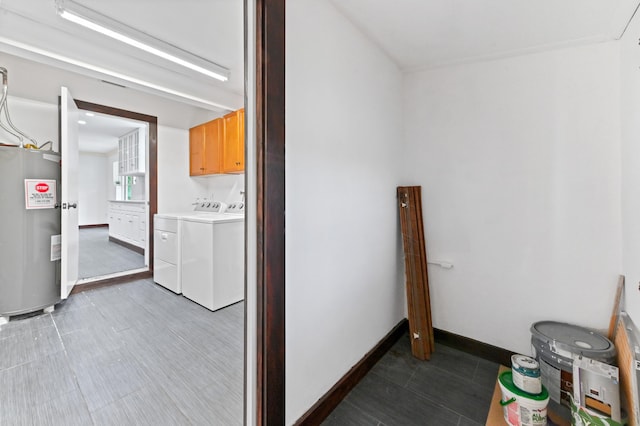 laundry area with washer and clothes dryer, cabinets, and water heater