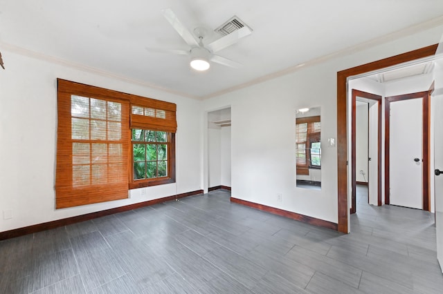 spare room with ceiling fan, crown molding, and dark hardwood / wood-style floors