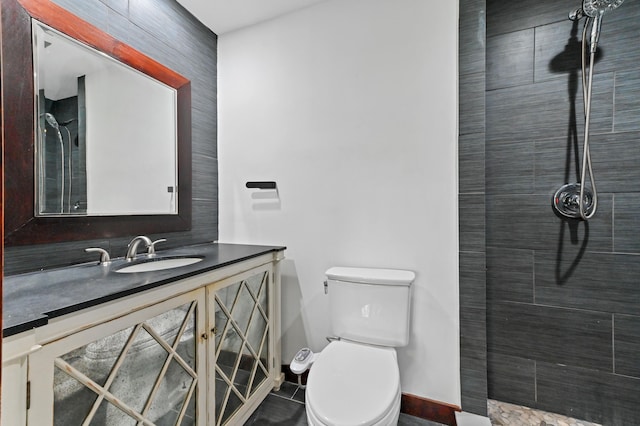 bathroom featuring tile patterned flooring, vanity, and toilet