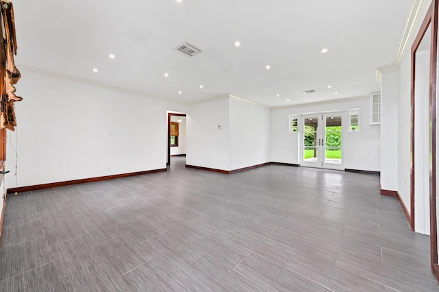 unfurnished room featuring crown molding and french doors