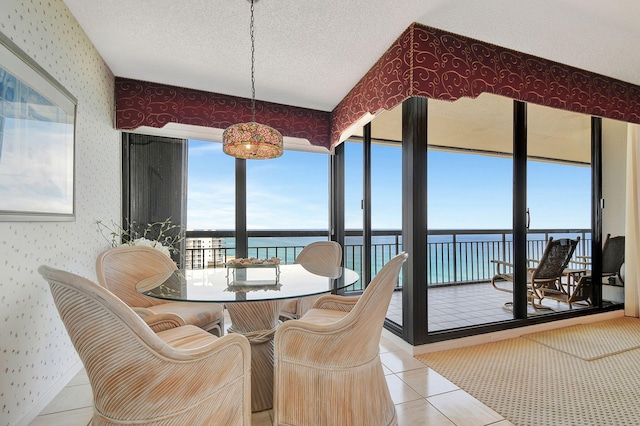 sunroom / solarium featuring a water view