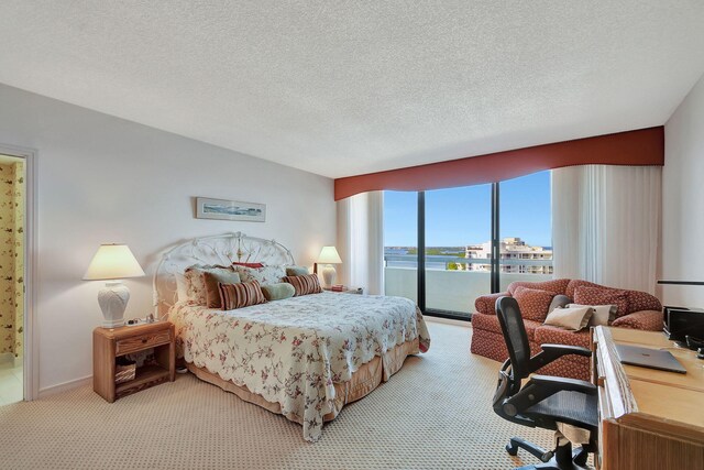 4000 N Ocean Dr Unit 2401, Singer Island, FL 33404 - carpeted bedroom featuring a textured ceiling and access to outside