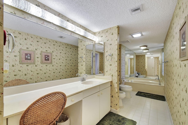 full bathroom featuring vanity, toilet, a bidet, a textured ceiling, and tile patterned flooring