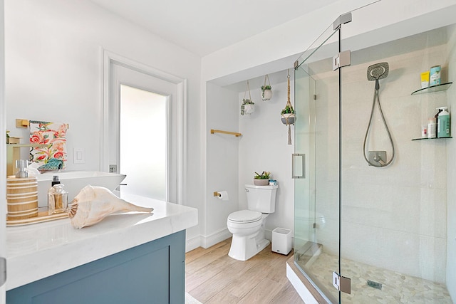 bathroom with an enclosed shower, hardwood / wood-style floors, vanity, and toilet