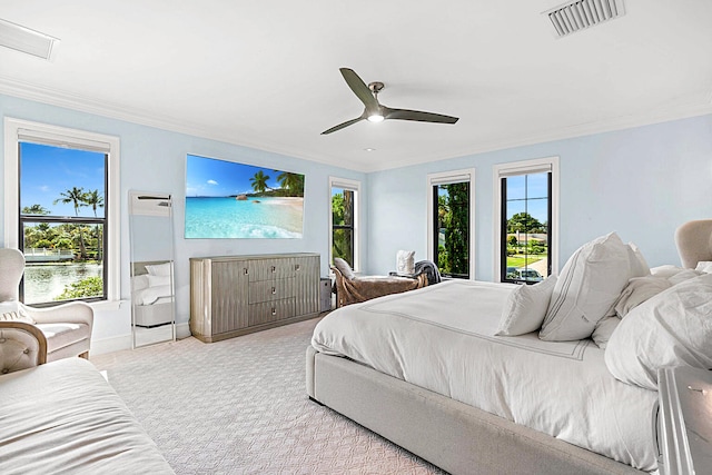 bedroom featuring ornamental molding, light colored carpet, and ceiling fan