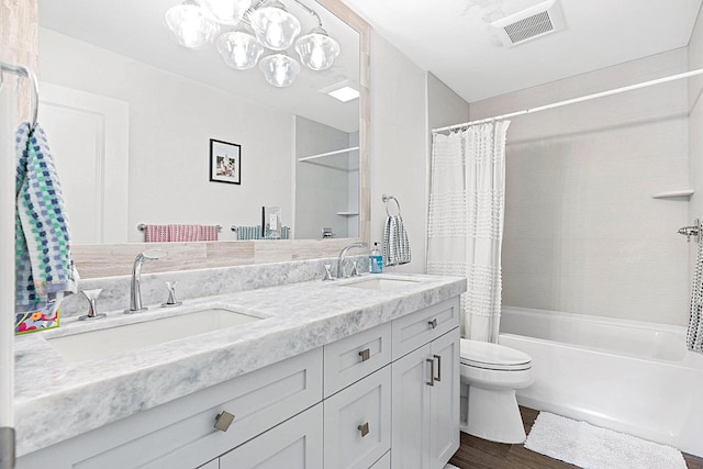 full bathroom featuring hardwood / wood-style flooring, toilet, shower / tub combo, and vanity