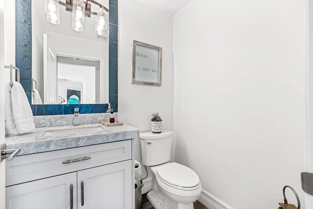 bathroom featuring toilet and vanity