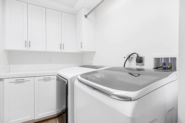 washroom with cabinets, dark hardwood / wood-style floors, and washer and dryer