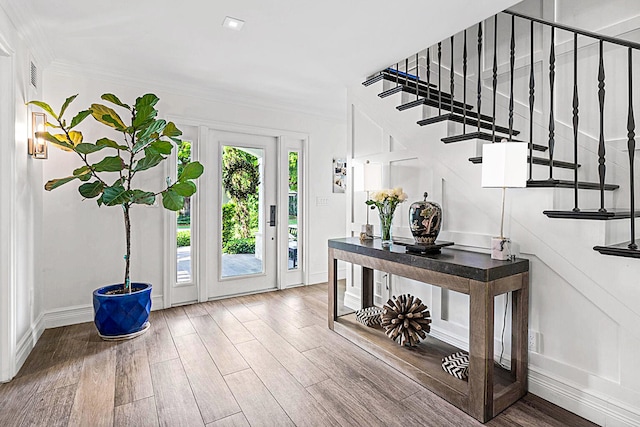 entryway featuring ornamental molding and wood-type flooring