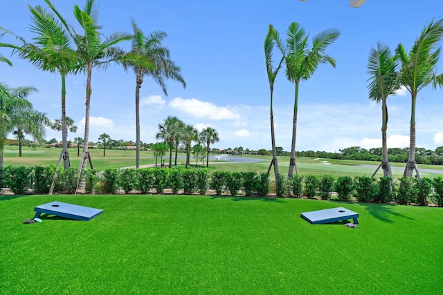 view of community with a yard and a water view