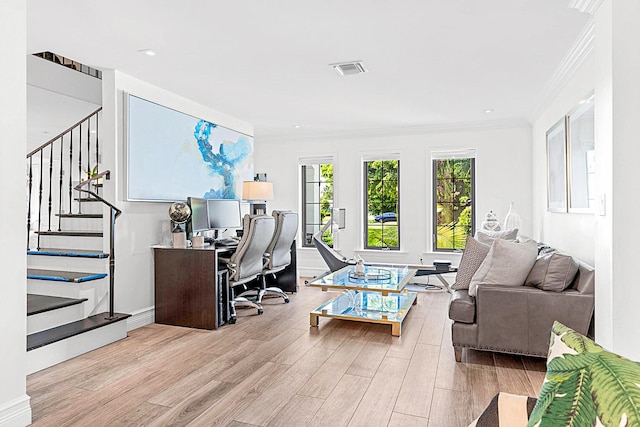 office area with light hardwood / wood-style floors and crown molding