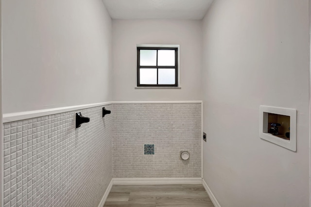 washroom with light wood-type flooring, tile walls, washer hookup, and electric dryer hookup