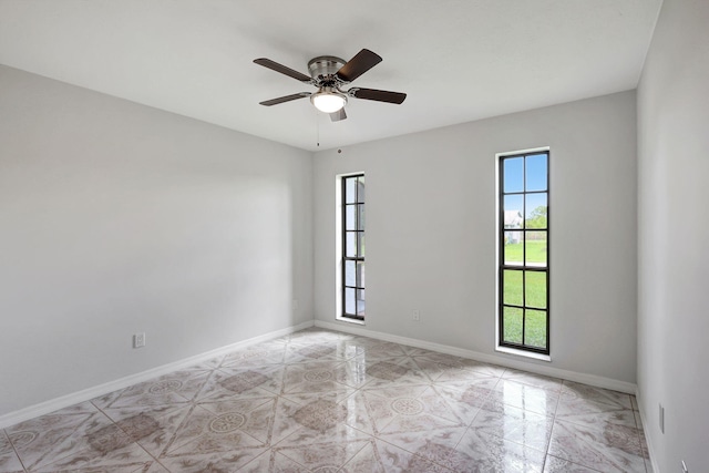 unfurnished room featuring ceiling fan and a healthy amount of sunlight