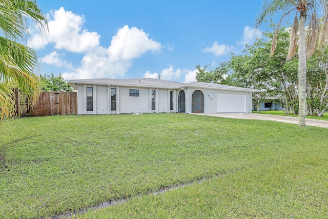 ranch-style house with a garage and a front lawn