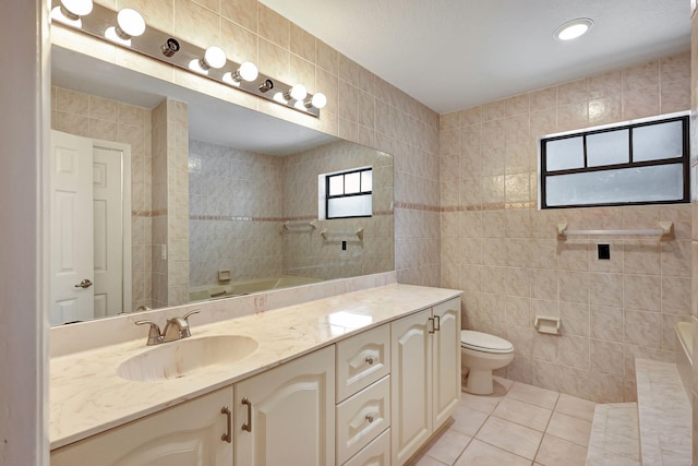 bathroom featuring tile walls, tile patterned floors, vanity, and toilet