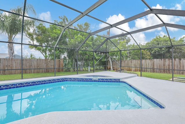 view of swimming pool with a patio, a jacuzzi, and a lanai