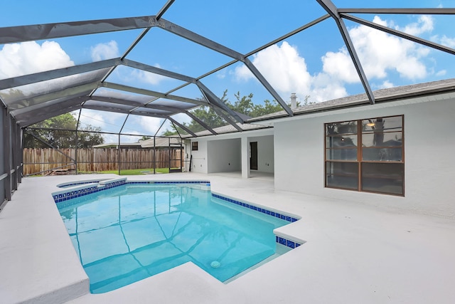 view of swimming pool featuring a patio and glass enclosure