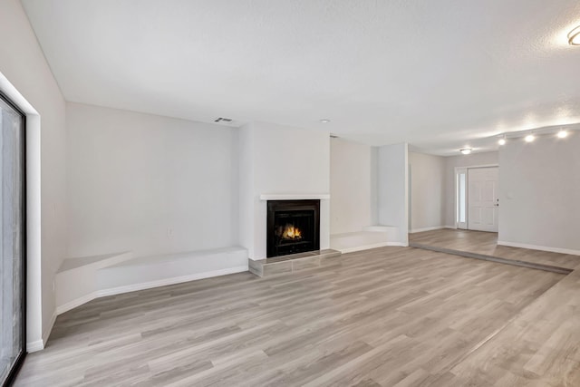 unfurnished living room featuring light wood-type flooring