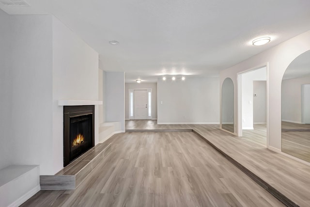 unfurnished living room with light hardwood / wood-style floors