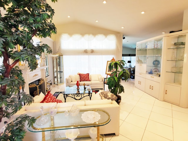 living room featuring lofted ceiling and light tile patterned floors