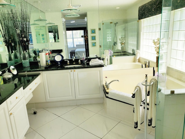 bathroom featuring tile patterned floors, vanity, and independent shower and bath