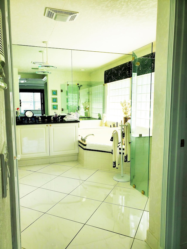 bathroom featuring separate shower and tub, tile patterned floors, and vanity