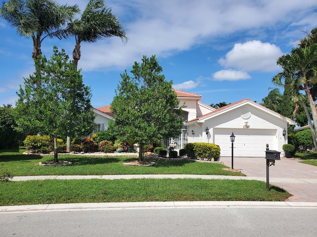 view of front of house featuring a garage and a front yard