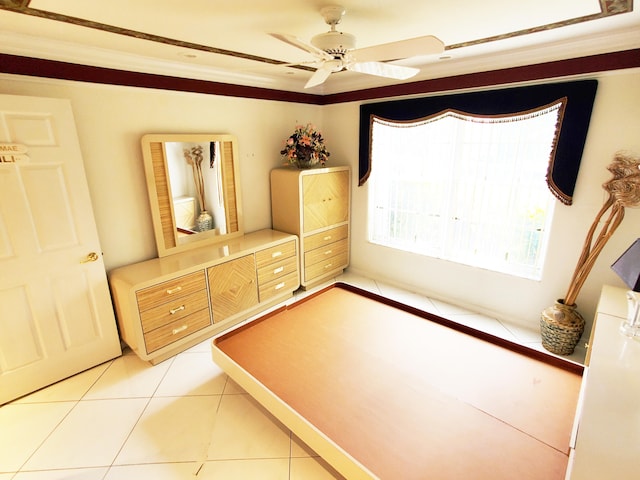 unfurnished bedroom featuring crown molding, tile patterned floors, and ceiling fan