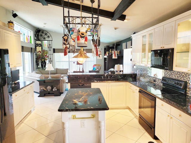 kitchen with beamed ceiling, sink, decorative light fixtures, black appliances, and a center island