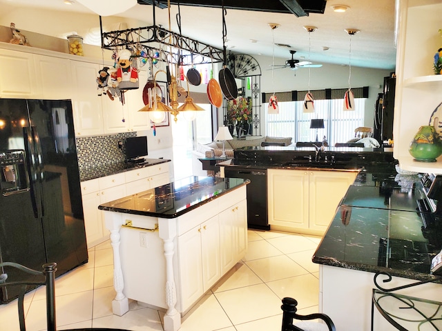 kitchen with kitchen peninsula, black appliances, white cabinetry, and a center island