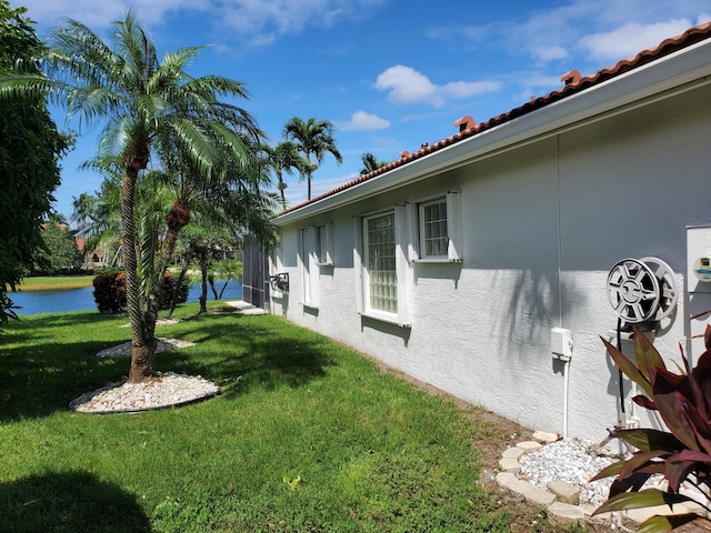 view of property exterior with a yard