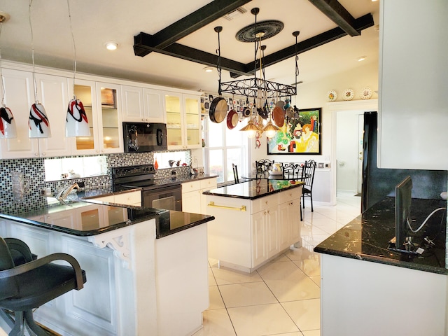 kitchen with a kitchen island, beam ceiling, hanging light fixtures, white cabinets, and black appliances