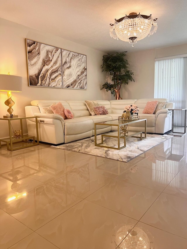 tiled living room featuring an inviting chandelier and a textured ceiling